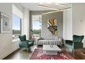 Comfortable living room featuring modern artwork, a plush sofa, stylish chairs, and large windows for natural light at 3820 Roswell Ne Rd # 510, Atlanta, GA 30342