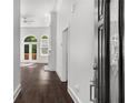 Bright foyer with hardwood floors leading to a spacious living area with french doors at 7025 Bavarian Wood Pl, Buford, GA 30518