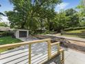 Newly installed driveway with a detached garage, complemented by stylish wood and metal railings at 1603 Ezra Church Nw Dr, Atlanta, GA 30314