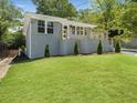 Charming gray brick home with a well-manicured front yard and a modern-railed front porch at 1603 Ezra Church Nw Dr, Atlanta, GA 30314