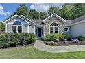 Inviting entrance with landscaped walkway leading to the front door at 1882 Flowering Dr, Grayson, GA 30017