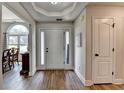 Bright foyer with wood floors, white walls, and view to dining area at 1882 Flowering Dr, Grayson, GA 30017
