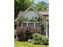 Close-up of a home's facade with rose bushes climbing the exterior at 1256 Euclid Ne Ave, Atlanta, GA 30307