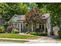 Charming house with a stone chimney, covered porch, and detached garage at 1256 Euclid Ne Ave, Atlanta, GA 30307