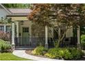 Inviting front porch with stone detail, black railing, and a stone walkway at 1256 Euclid Ne Ave, Atlanta, GA 30307