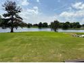 Expansive backyard with lush lawn gently sloping to a tranquil lake at 2657 Gray Mill Way, Loganville, GA 30052