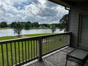 Peaceful lake view from the patio, enhanced by a small table for outdoor relaxation at 2657 Gray Mill Way, Loganville, GA 30052