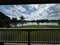 Stunning lake view from a balcony, complemented by lush greenery and a serene atmosphere at 2657 Gray Mill Way, Loganville, GA 30052