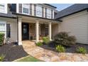 Inviting entrance with a stone walkway leading to a covered front porch at 5440 Old Haven Ct, Cumming, GA 30041