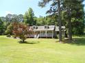 Cozy one-story home with inviting front porch and lovely landscaping at 6 Fairfield Dr, Ellenwood, GA 30294