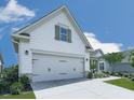 Angle showing the two-car garage of this home with white siding and stone veneer at 603 Canyon Overlook, Canton, GA 30114
