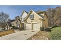 Side view of a two-story home featuring a two-car garage and landscaped yard at 2331 Flowerdale Ct, Douglasville, GA 30135