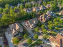 A beautiful community featuring tree-lined streets and well-maintained homes, captured from an aerial view at 2604 Heltonwood Ct, Buford, GA 30519