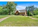 Well-manicured lawn and landscaping enhance the curb appeal of this home at 179 Hogan Rd, Brooks, GA 30205