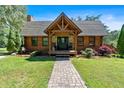 Inviting front porch with a stone pathway and well-maintained landscaping at 179 Hogan Rd, Brooks, GA 30205