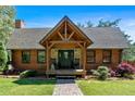 Charming house boasting a welcoming front porch with stone accents and rocking chairs, perfect for relaxing at 179 Hogan Rd, Brooks, GA 30205