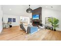 Open-concept living room with hardwood floors, vaulted ceilings, and modern fireplace at 1815 Coventry Rd, Decatur, GA 30030
