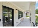 Inviting porch with tiled floor, stylish lighting, and a cozy wooden bench at 1815 Coventry Rd, Decatur, GA 30030