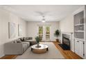 Bright living room with fireplace, built-in shelving, hardwood floors, and French doors offering abundant natural light at 3655 Habersham Ne Rd # 203, Atlanta, GA 30305