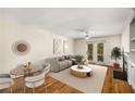 Inviting living room with French doors, a ceiling fan, fireplace, and hardwood floors for a cozy ambiance at 3655 Habersham Ne Rd # 203, Atlanta, GA 30305