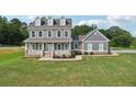 Charming two-story home features a covered porch and well-manicured lawn at 615 Henderson Mill Rd, Covington, GA 30014