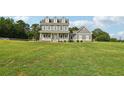 Charming two-story home features a covered porch and well-manicured lawn at 615 Henderson Mill Rd, Covington, GA 30014