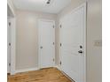 Neutral hallway with wood-look flooring and white doors at 1368 Poplar Pointe Se, Smyrna, GA 30082