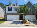 Charming two-story home featuring a two-car garage, brick accents, and a well-maintained front yard at 2141 Spikerush Way, Buford, GA 30519