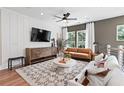 Stylish living room with hardwood floors, shiplap accent wall, modern furniture, and ample natural light at 2535 Astaire Ct, Atlanta, GA 30318