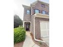 Beautiful brick home exterior with a front door and landscaped yard at 5850 Shiloh Woods Dr, Cumming, GA 30040