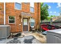 Enclosed brick back patio with outdoor rug, privacy fence, and rear entry door at 105 North River Dr # A, Atlanta, GA 30350