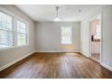 Bright dining room featuring hardwood floors and a view into the kitchen and living spaces at 1716 Beacon Hill Ne Blvd, Atlanta, GA 30329