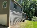 Side view of a well-maintained house showcasing its clean siding and neat landscaping at 4433 Ford Pl, Snellville, GA 30039
