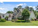 Beautiful brick home boasts a well-maintained lawn, mature trees, and lush landscaping for a serene setting at 543 Serene Waters Trl, Jonesboro, GA 30236