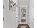 Bright foyer featuring white walls, hardwood floors, decorative door, and closet for coats and storage at 10650 Colony Glen Dr, Johns Creek, GA 30022