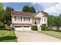 Charming two-story home with a well-manicured lawn, attached garage, and a welcoming front porch at 2577 Abbotts Glen Nw Dr, Acworth, GA 30101