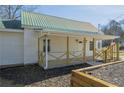 Exterior view of home featuring light siding, wooden porch railing, and a metal roof at 3107 Hendrix Circle Sw, Covington, GA 30014