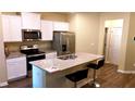 Well-equipped kitchen with stainless steel appliances, granite countertops and center island at 473 Broder Farms Dr, Stockbridge, GA 30281