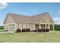Beautifully landscaped home featuring an attached garage and inviting front porch at 625 Henderson Mill Rd, Covington, GA 30014