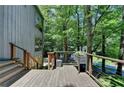 Spacious outdoor deck with metal railings, stone accents, and views of the surrounding greenery at 945 Tiber Cir, Alpharetta, GA 30022