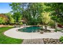 Enjoy the backyard pool with the mature trees offering an outdoor oasis for relaxation and entertainment at 1556 Gaylor Se Dr, Smyrna, GA 30082