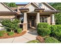 Inviting front porch with stone accents and lush landscaping, offering great curb appeal at 1556 Gaylor Se Dr, Smyrna, GA 30082