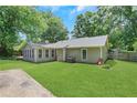 Spacious backyard with a sunroom and a well-maintained lawn perfect for outdoor activities at 1605 Saddlecreek Rd, Auburn, GA 30011
