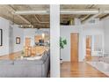 Open-concept loft featuring a living room, kitchen, and a glimpse of the bedroom and bathroom at 3235 Roswell Ne Rd # 702, Atlanta, GA 30305