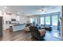 Bright living space with a view of the modern kitchen and comfortable seating area at 3410 Summerpoint Xing, Cumming, GA 30028