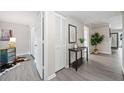 Inviting hallway with closets, modern decor, and wood-look floors leading to various rooms at 705 Beaufort Cir, Duluth, GA 30096