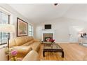 Bright living room with hardwood floors, a cozy fireplace, and lots of natural light at 2031 Dennis Pl, Buford, GA 30519