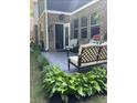 Back patio features an outdoor seating and grill, adjacent to well-maintained lawn and greenery at 201 Jonquil Spring Rd, Woodstock, GA 30188