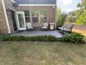 Back patio with outdoor seating and grill, perfect for entertaining or relaxing in the backyard at 201 Jonquil Spring Rd, Woodstock, GA 30188