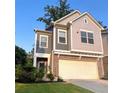 Charming two-story townhouse with a brick facade and attached two-car garage at 201 Jonquil Spring Rd, Woodstock, GA 30188